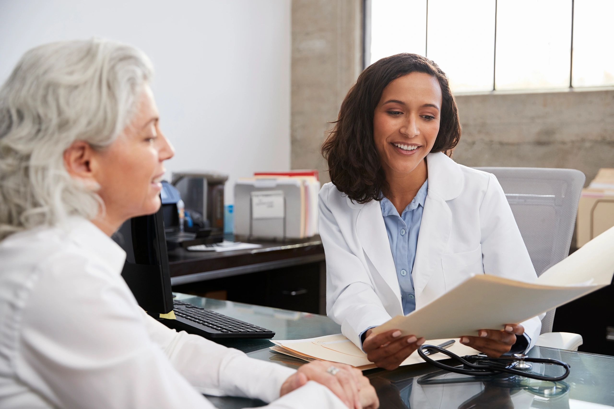 Doctor consulting with a senior patient