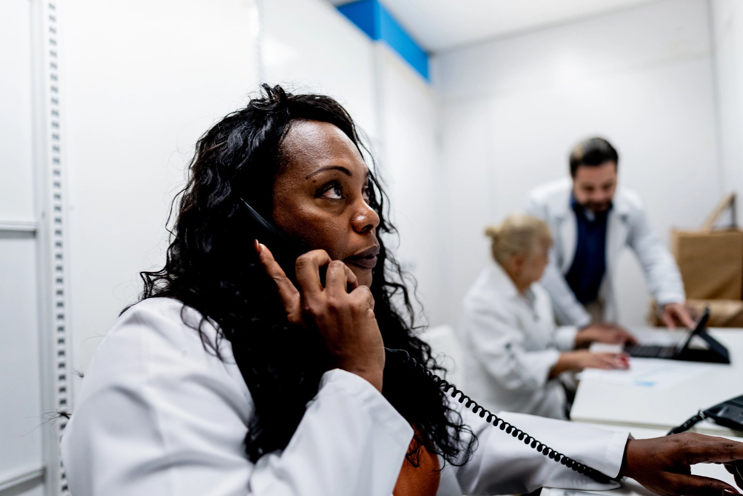 Patient support representative assisting a patient